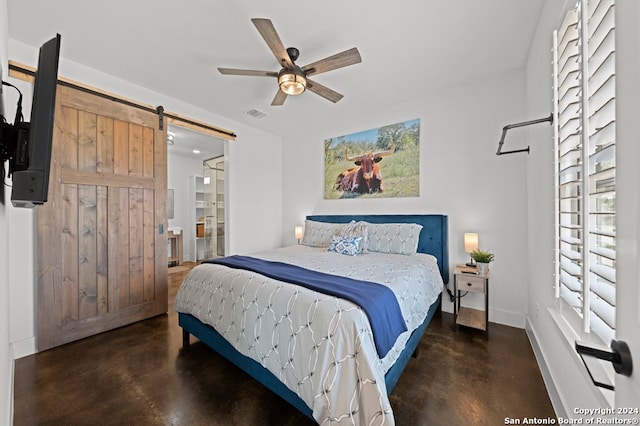 bedroom featuring ceiling fan and a barn door