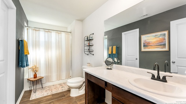 bathroom featuring wood-type flooring, vanity, toilet, and a shower with shower curtain