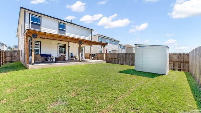 back of property with a lawn and a patio area