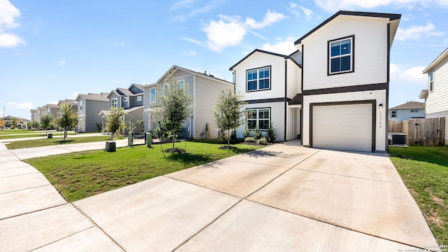 view of front of house featuring a front yard, a garage, and central air condition unit