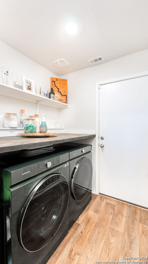 laundry area featuring light hardwood / wood-style floors and independent washer and dryer