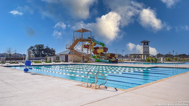 view of swimming pool featuring a water slide