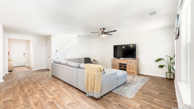 living room with ceiling fan and light hardwood / wood-style floors