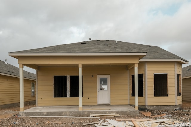 8432 Roadrunner Psge, San Antonio, TX 78222 - rear view of house featuring roof with shingles and a patio area