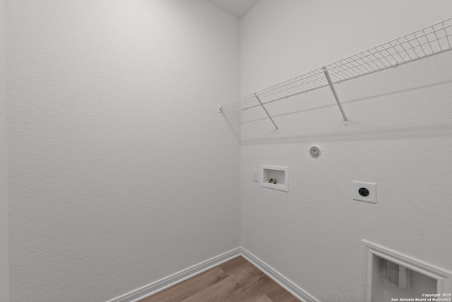 8432 Roadrunner Psge, San Antonio, TX 78222 - laundry room featuring hookup for an electric dryer, washer hookup, baseboards, wood finished floors, and laundry area