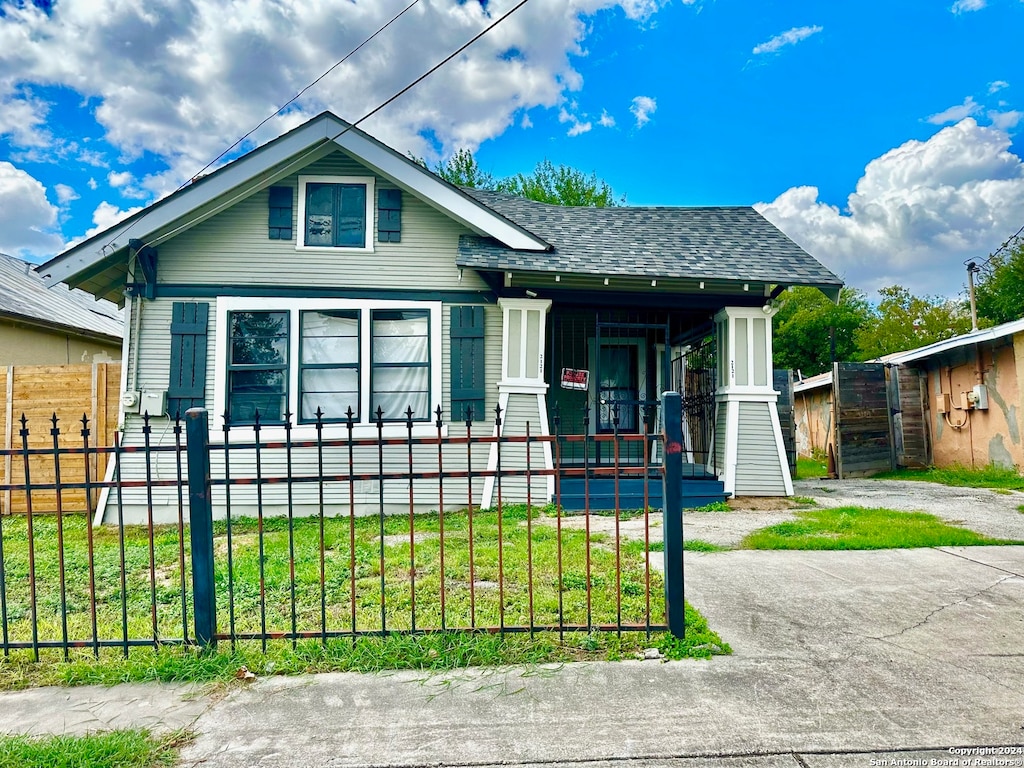 bungalow featuring a front lawn and covered porch