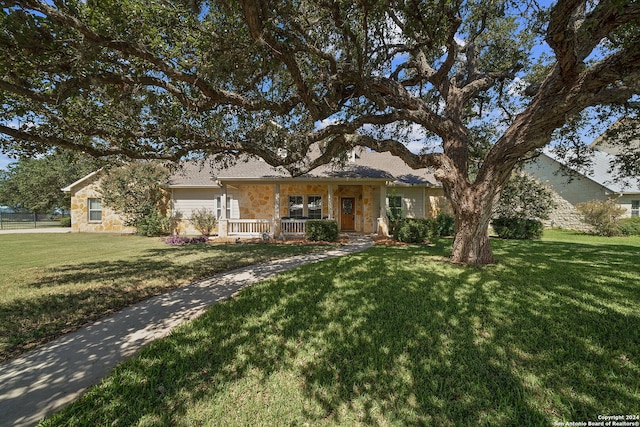 single story home featuring covered porch and a front yard