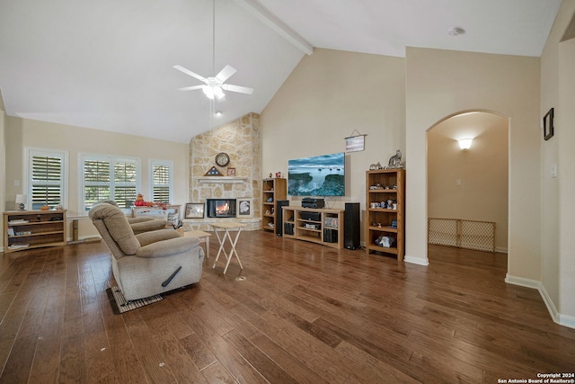 living room featuring ceiling fan, a fireplace, dark wood-type flooring, and high vaulted ceiling