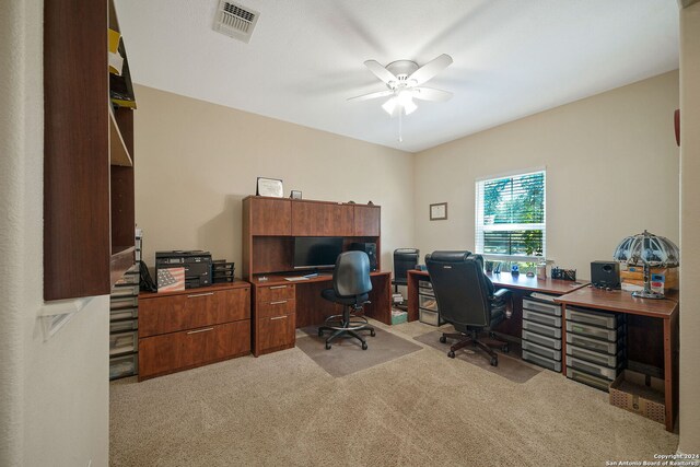 office space featuring light carpet and ceiling fan