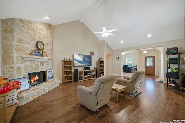 living room with high vaulted ceiling, a fireplace, beamed ceiling, ceiling fan, and dark hardwood / wood-style floors