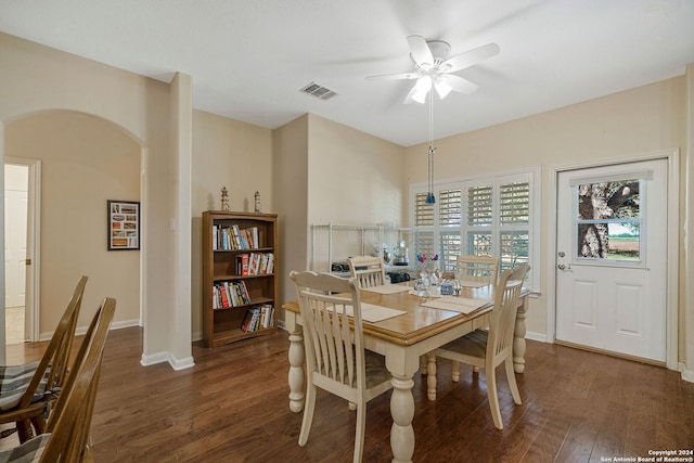 dining room with ceiling fan and dark wood-type flooring