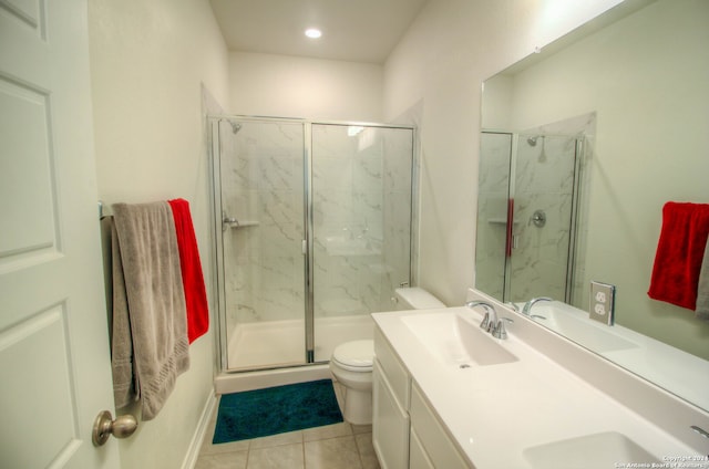 bathroom with tile patterned flooring, an enclosed shower, vanity, and toilet