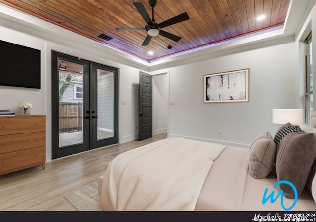 bedroom featuring wooden ceiling, access to exterior, ceiling fan, and a raised ceiling