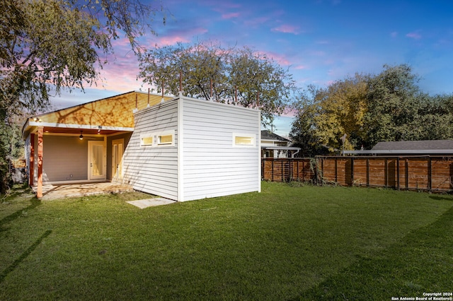 exterior space with a patio area and a lawn