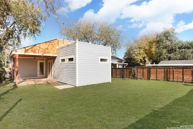 back of house featuring a yard and a patio