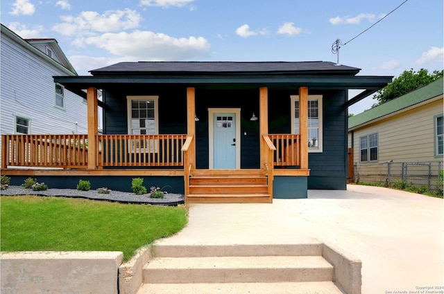 bungalow-style house featuring a porch and a front yard