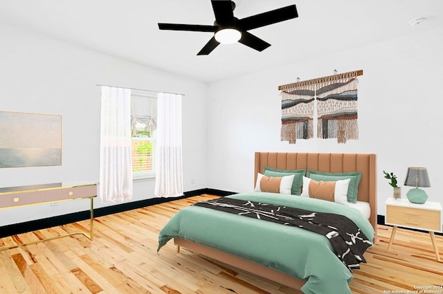 bedroom featuring hardwood / wood-style floors and ceiling fan