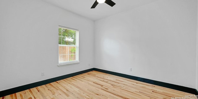 spare room with hardwood / wood-style flooring and ceiling fan