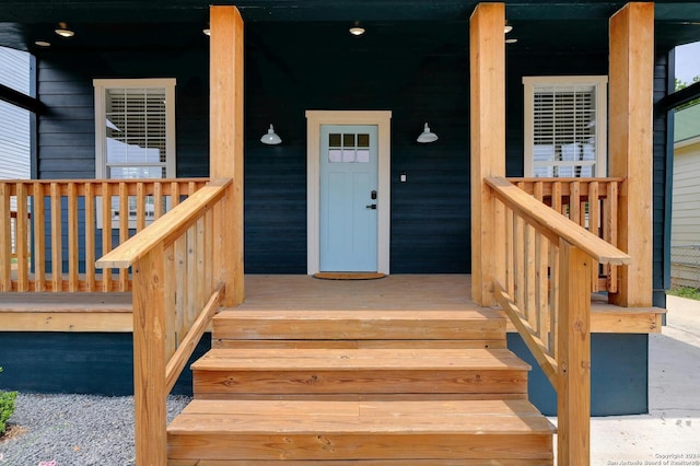 view of exterior entry with covered porch