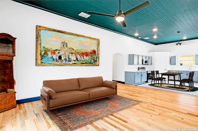 living room featuring sink, wooden ceiling, light wood-type flooring, and ceiling fan