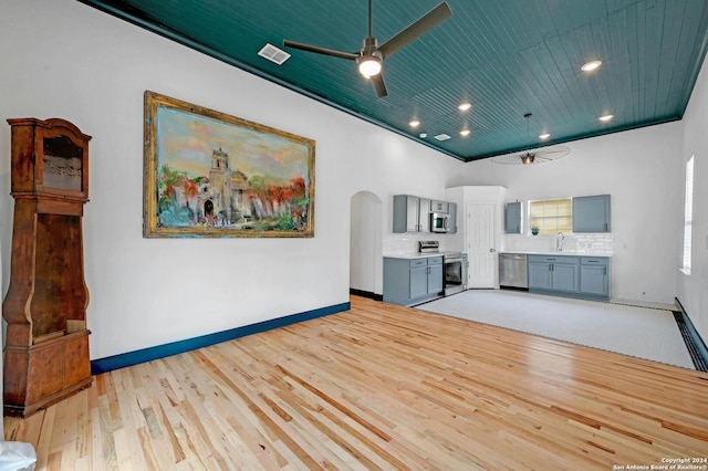 unfurnished living room featuring light hardwood / wood-style flooring, ornamental molding, wood ceiling, and ceiling fan