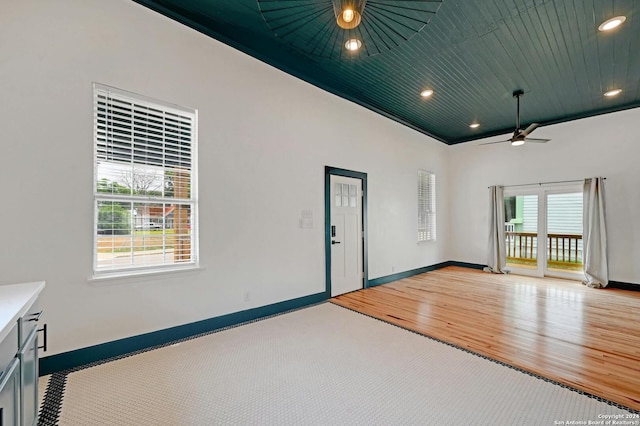 spare room with wood ceiling, ceiling fan, light wood-type flooring, and a wealth of natural light