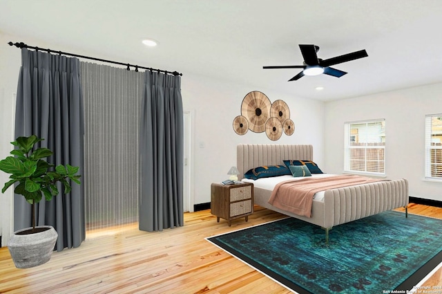 bedroom with hardwood / wood-style floors and ceiling fan