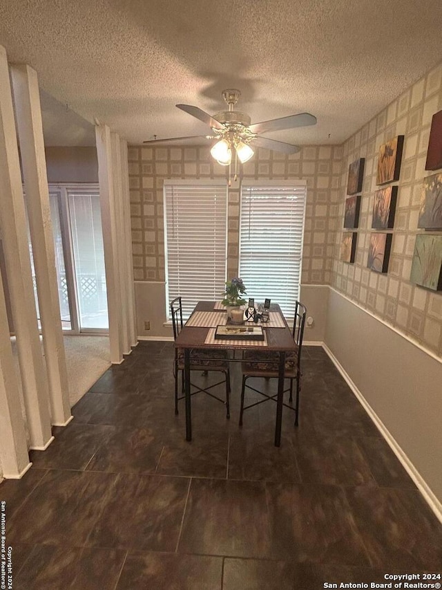 dining space with ceiling fan and a textured ceiling