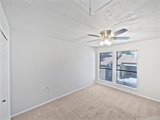 interior space with ceiling fan and a textured ceiling