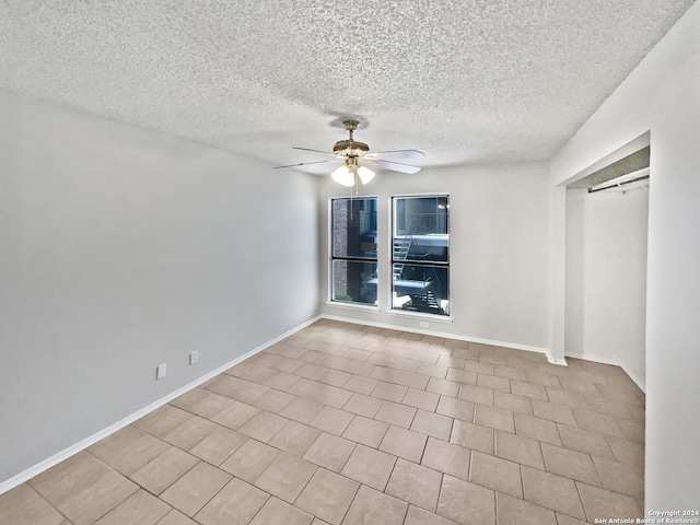 unfurnished bedroom featuring ceiling fan, a textured ceiling, and light tile patterned floors