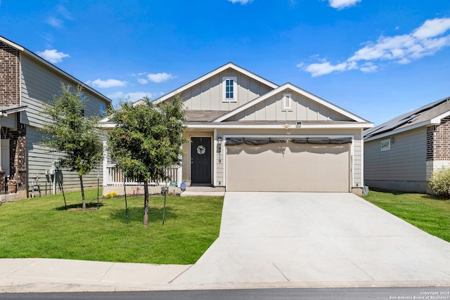 view of front of property featuring a front lawn and a garage