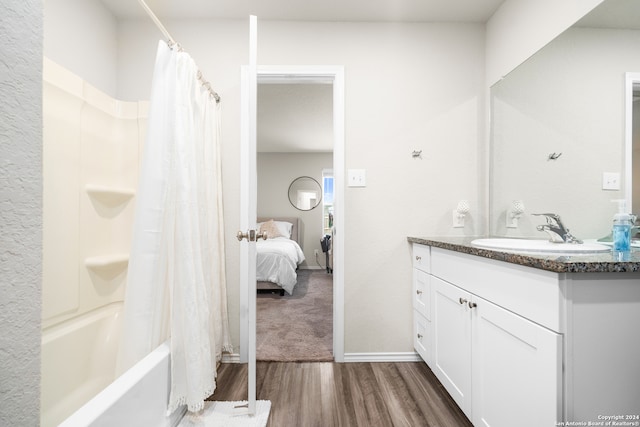 bathroom featuring vanity, shower / tub combo, and hardwood / wood-style floors