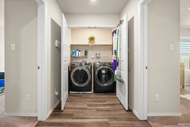 washroom featuring wood-type flooring and separate washer and dryer