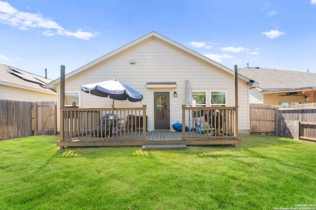 back of house with a lawn and a deck