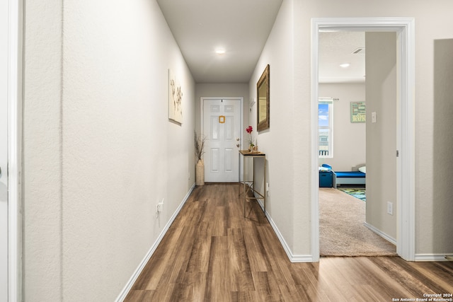 hallway with hardwood / wood-style flooring