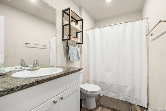 bathroom with hardwood / wood-style floors, vanity, toilet, and a shower with shower curtain