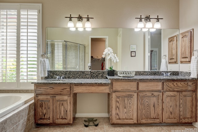 bathroom with tile patterned floors, separate shower and tub, and vanity