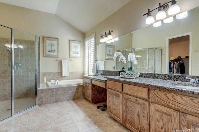 bathroom featuring vanity, tile patterned flooring, vaulted ceiling, and independent shower and bath