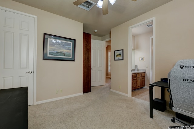 carpeted office space with ceiling fan