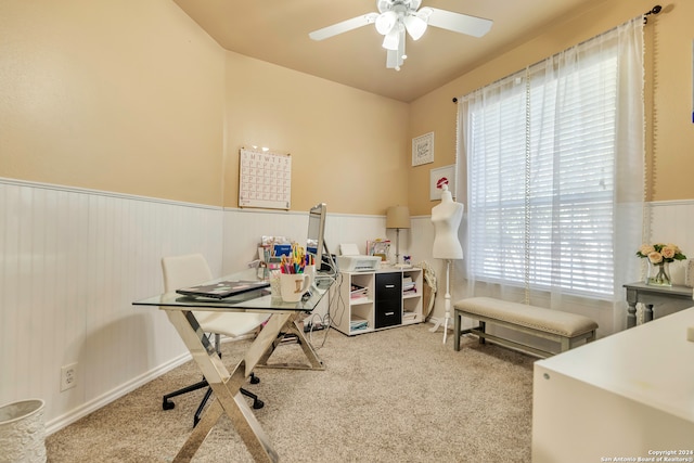 carpeted office space featuring ceiling fan and a healthy amount of sunlight