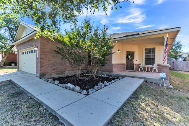 ranch-style home featuring a garage and covered porch