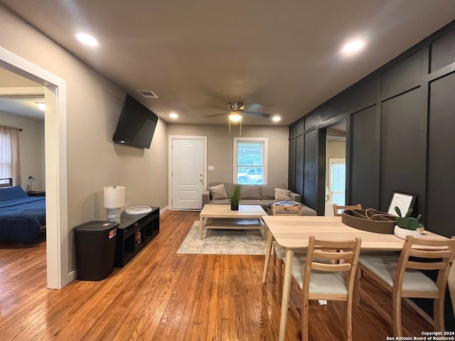 dining space with wood-type flooring and ceiling fan