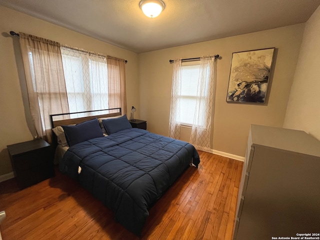 bedroom with hardwood / wood-style flooring