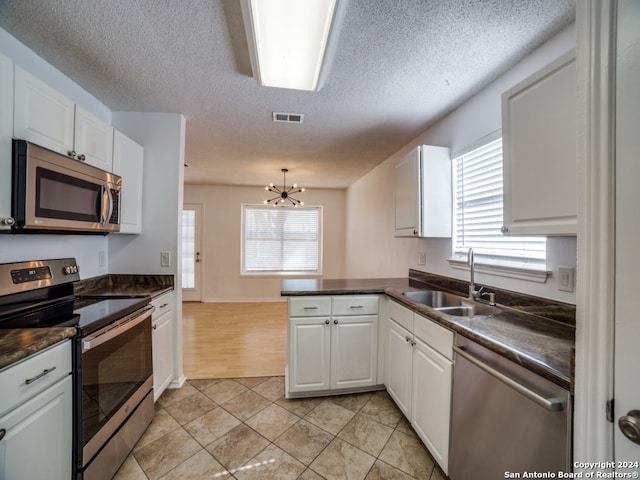 kitchen featuring white cabinets, sink, and appliances with stainless steel finishes