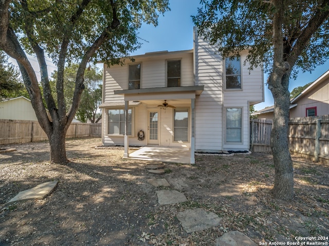 back of house with ceiling fan and a patio area