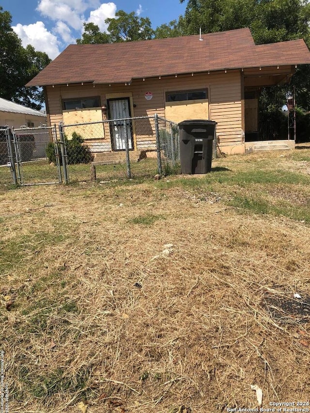 back of house with a lawn