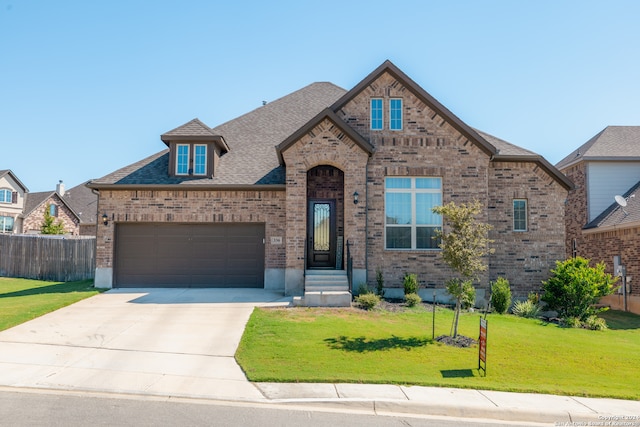 view of front of home featuring a front yard and a garage