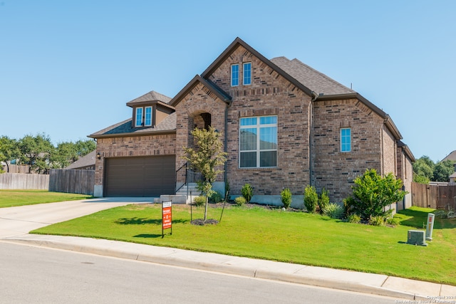 view of front of property featuring a front yard and a garage