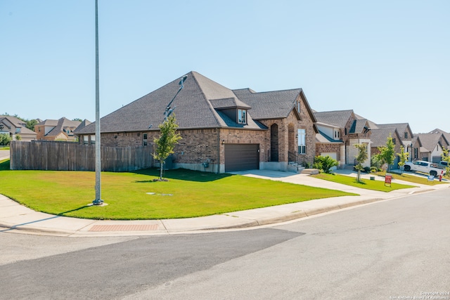 view of front of property with a garage and a front yard