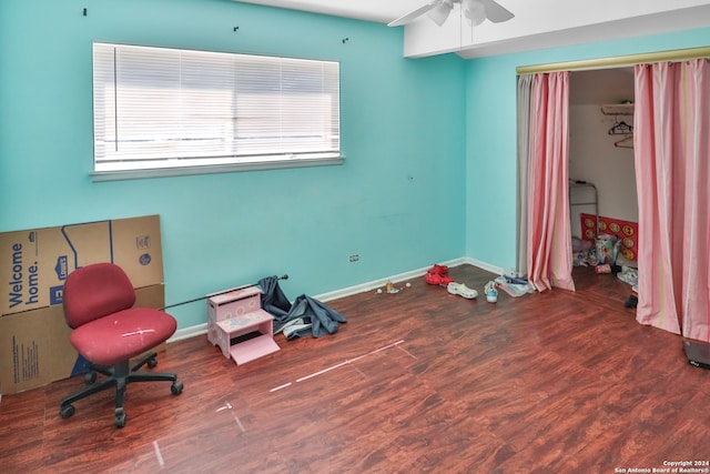 sitting room with ceiling fan, dark wood-type flooring, and a wealth of natural light